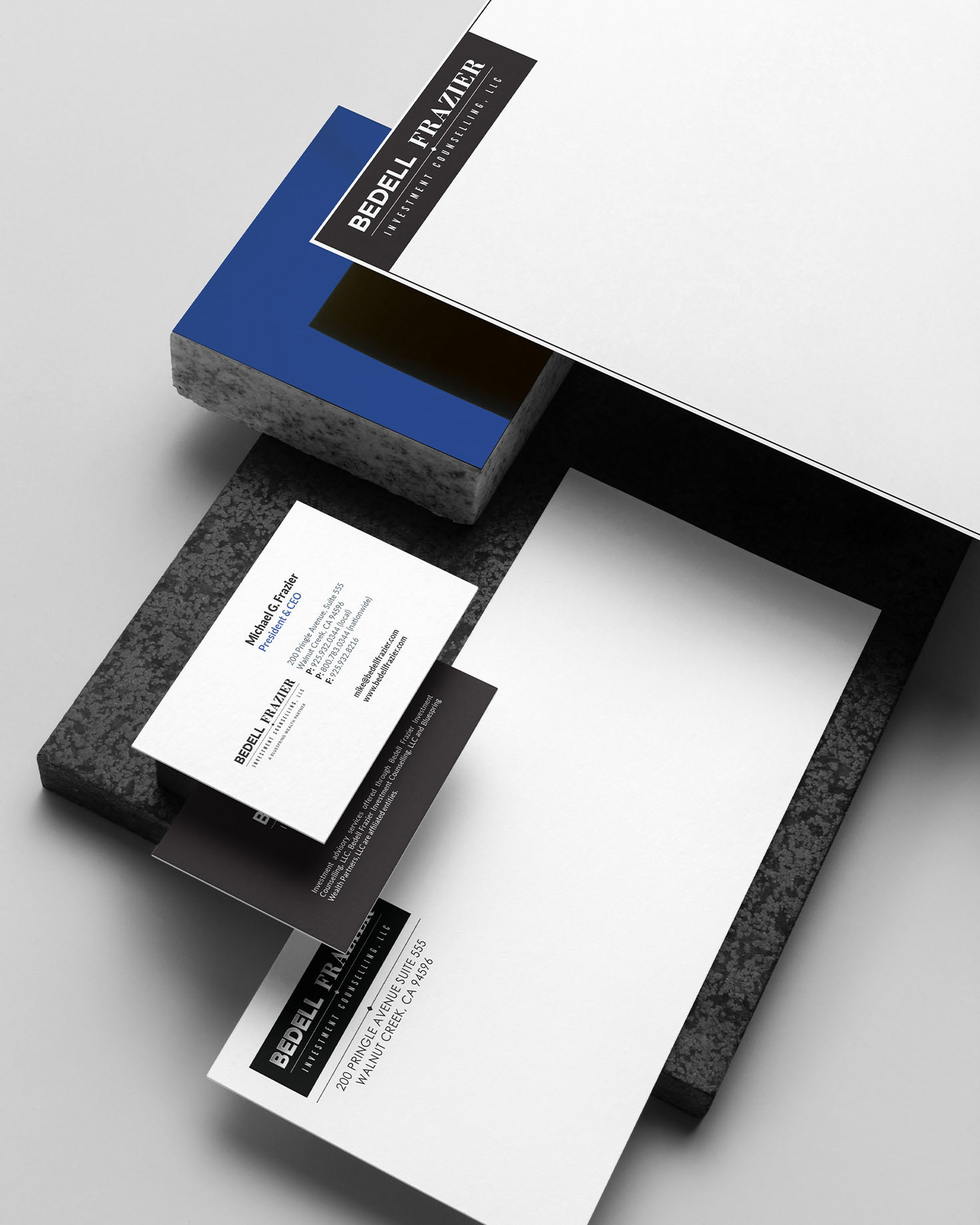 Bedell Frazier-branded stationery, including business cards and envelopes, highlighting the firm’s sleek, professional branding.