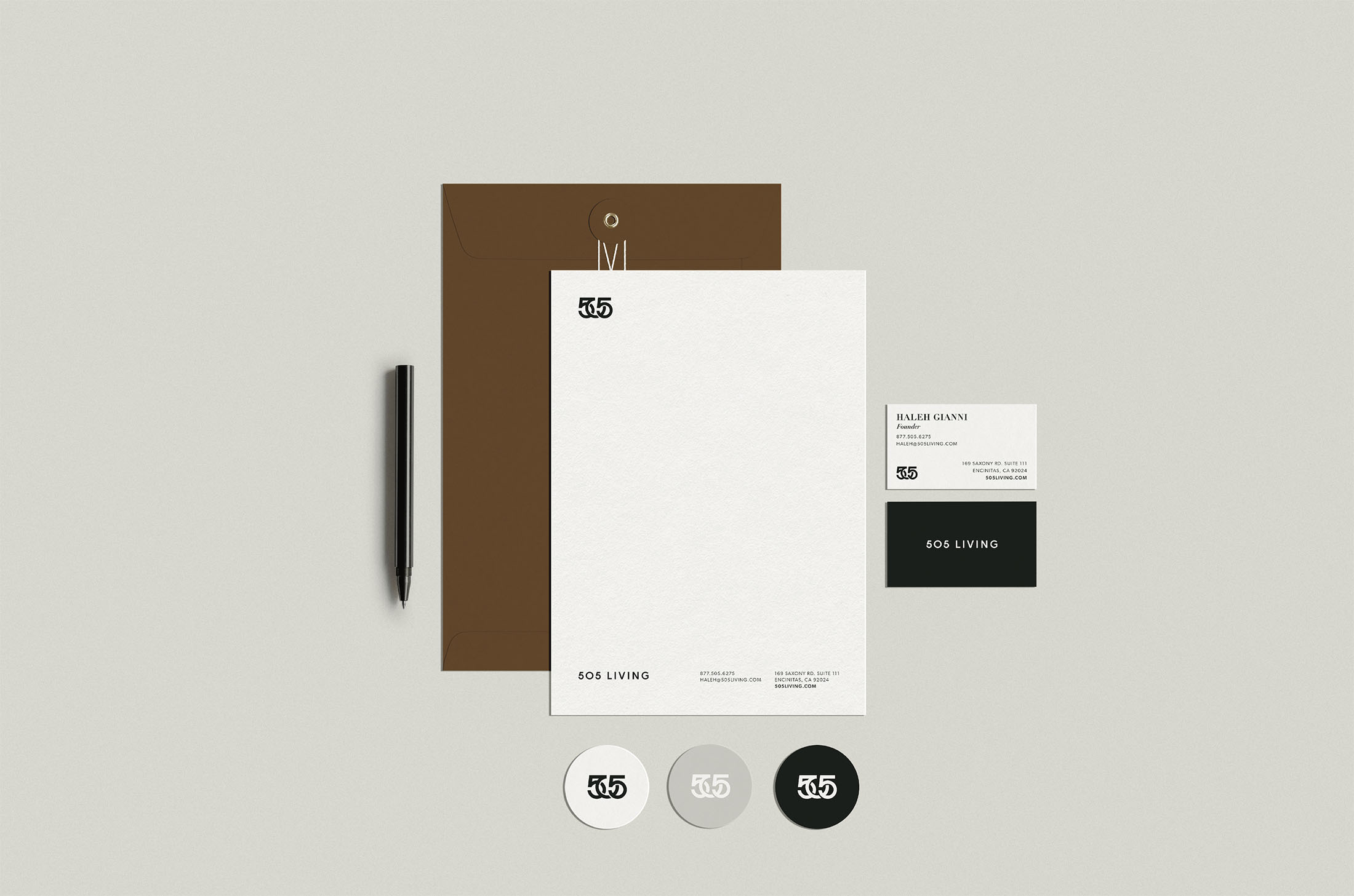 505 Living branded stationery set featuring a cohesive design with letterhead, business cards, and envelopes, emphasizing professionalism and a modern visual identity.