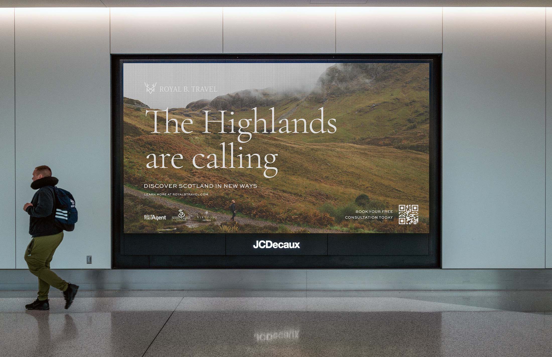 Royal B Travel advertisement displayed in an airport, featuring a Highlands landscape with the headline “The Highlands are calling” and branding elements.