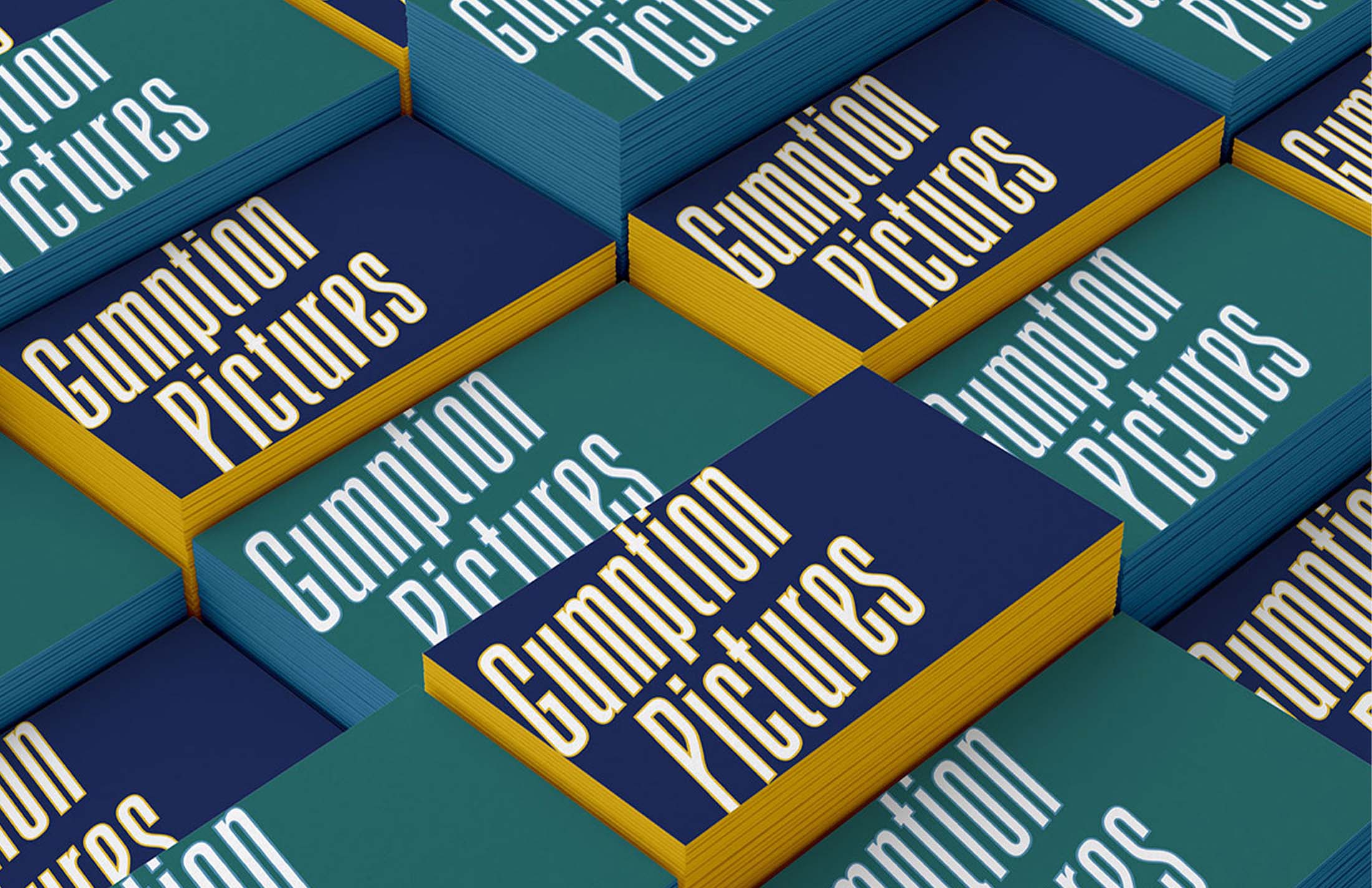 Custom business cards for Gumption Pictures featuring bold patterns and the brand’s logo in yellow and teal, designed for a dynamic and professional impression.