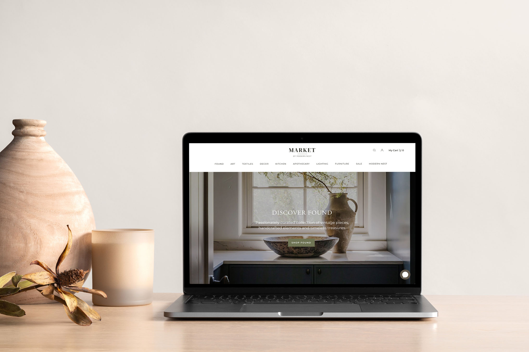 Website design for Modern Nest Homes displayed on a clean wooden desk with a desktop view showcasing a luxury kitchen project.