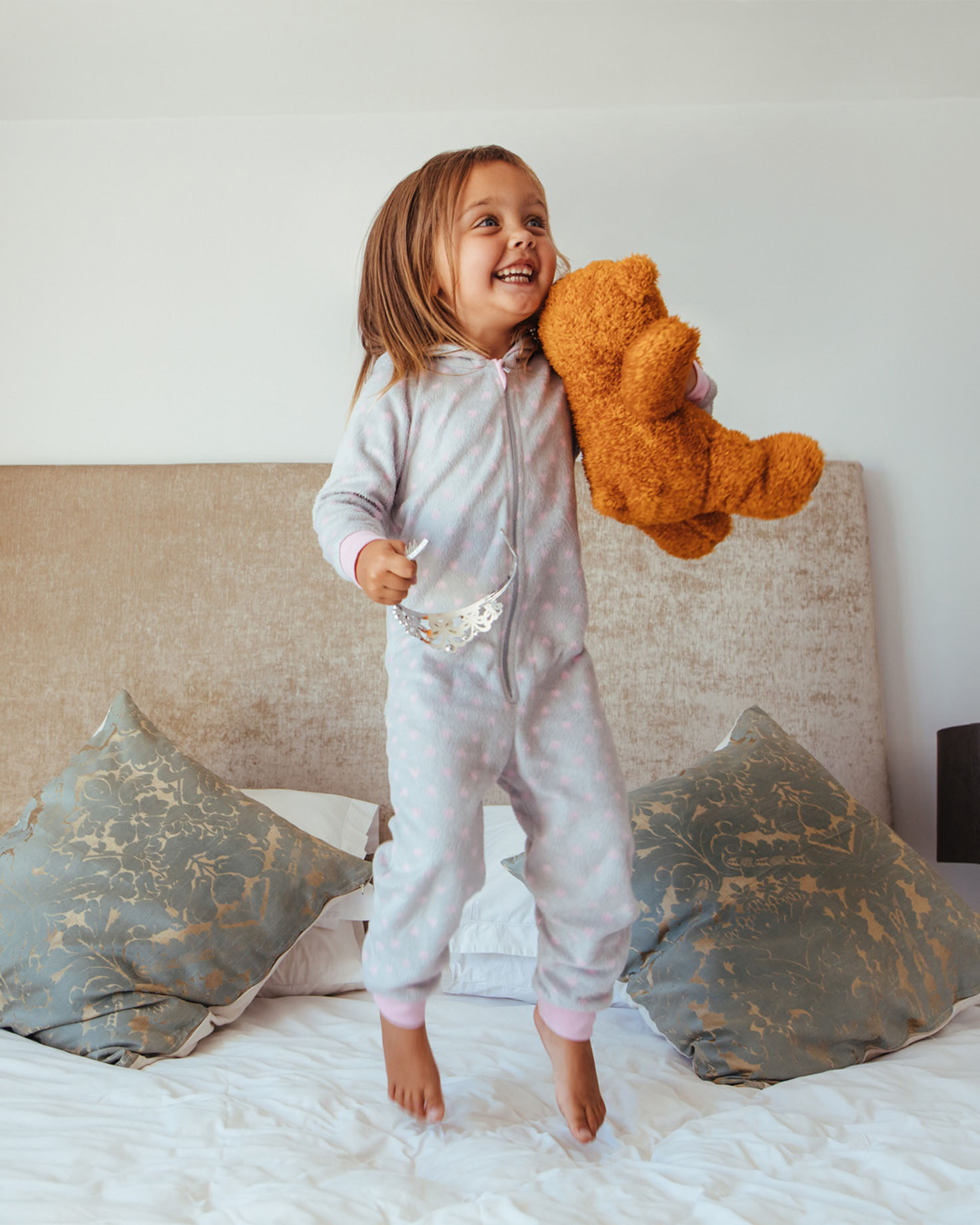 Portrait of a child holding a teddy bear, representing the personalized childcare services offered by Nannies by Noa.