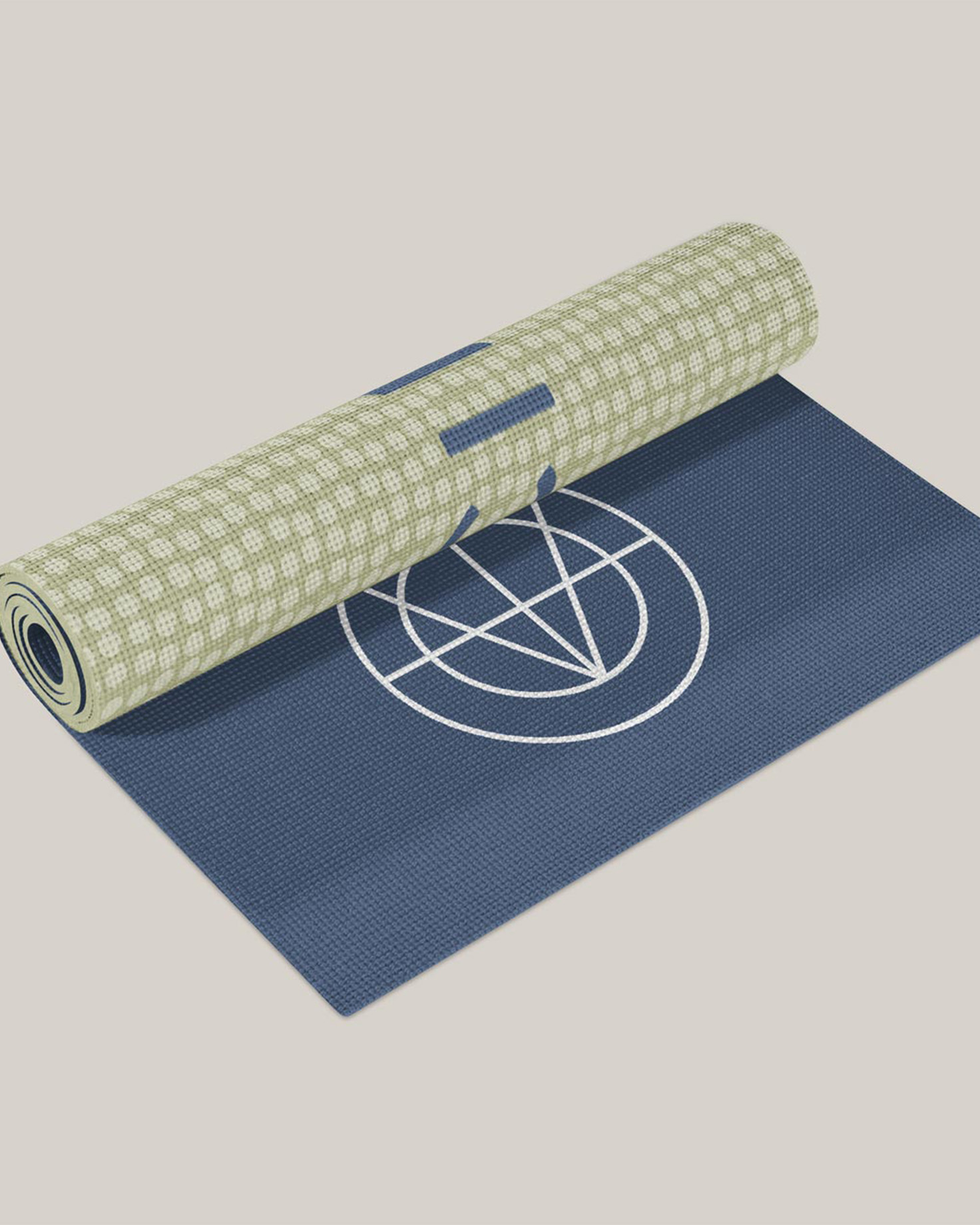 A custom Full Circle Wellness yoga mat in navy blue and green, featuring the brand’s circular logo design.