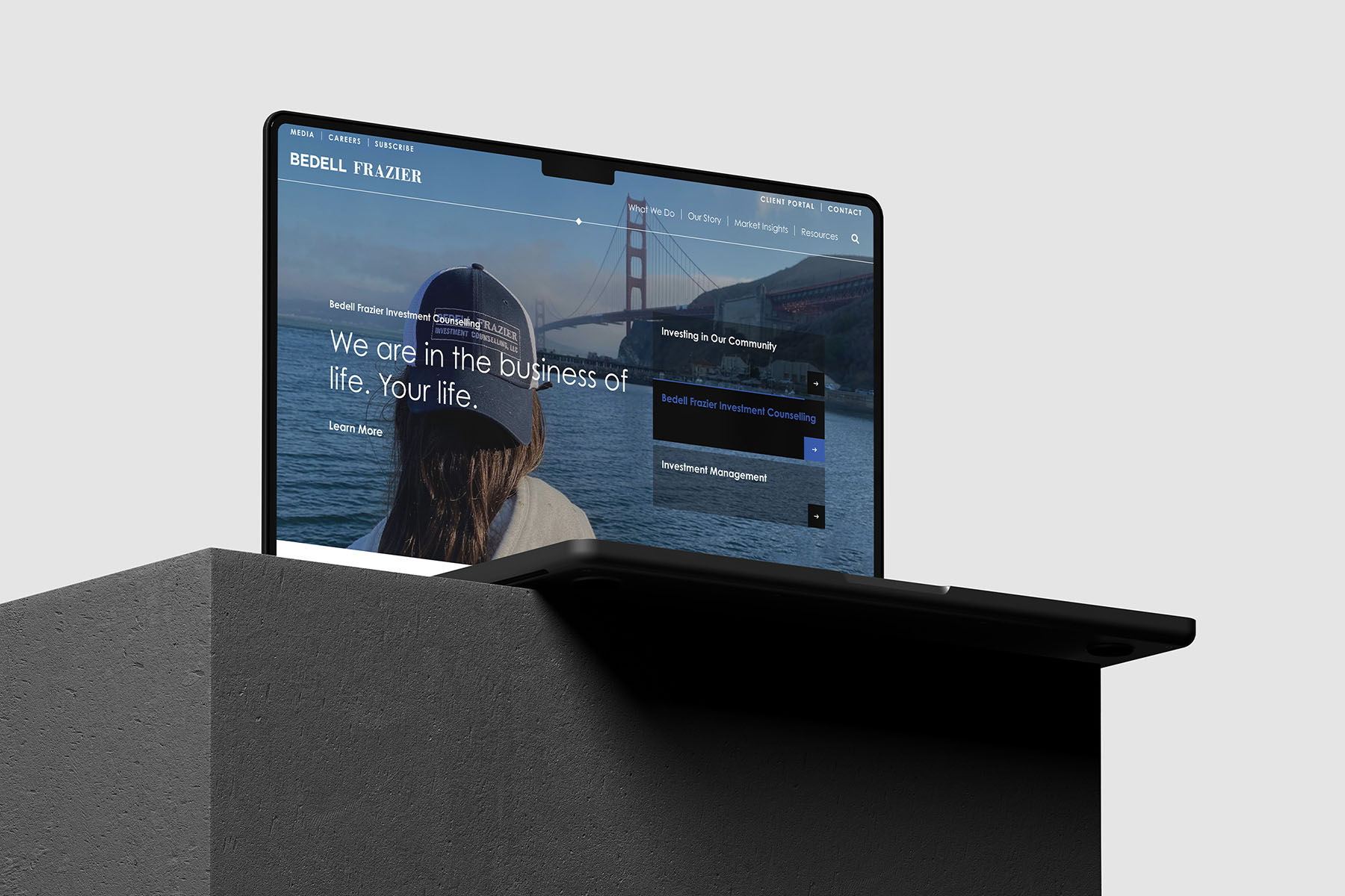 Laptop displaying Bedell Frazier’s website homepage, featuring a clear, user-friendly layout with a scenic view of the Golden Gate Bridge.