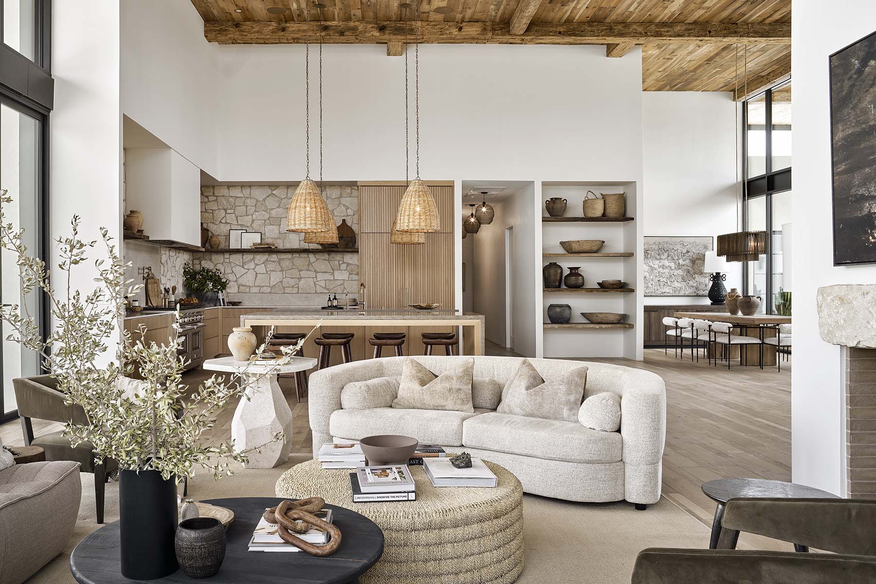 Elegant living room design with natural textures, wooden elements, and open shelving from Modern Nest’s custom home projects.