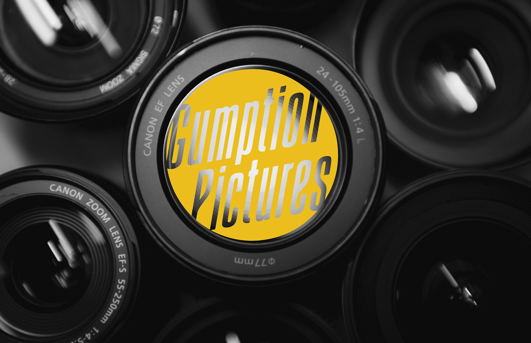 Gumption Pictures logo displayed within a camera lens, featuring bold yellow typography designed by Whiskey & Red to represent creativity and innovation.