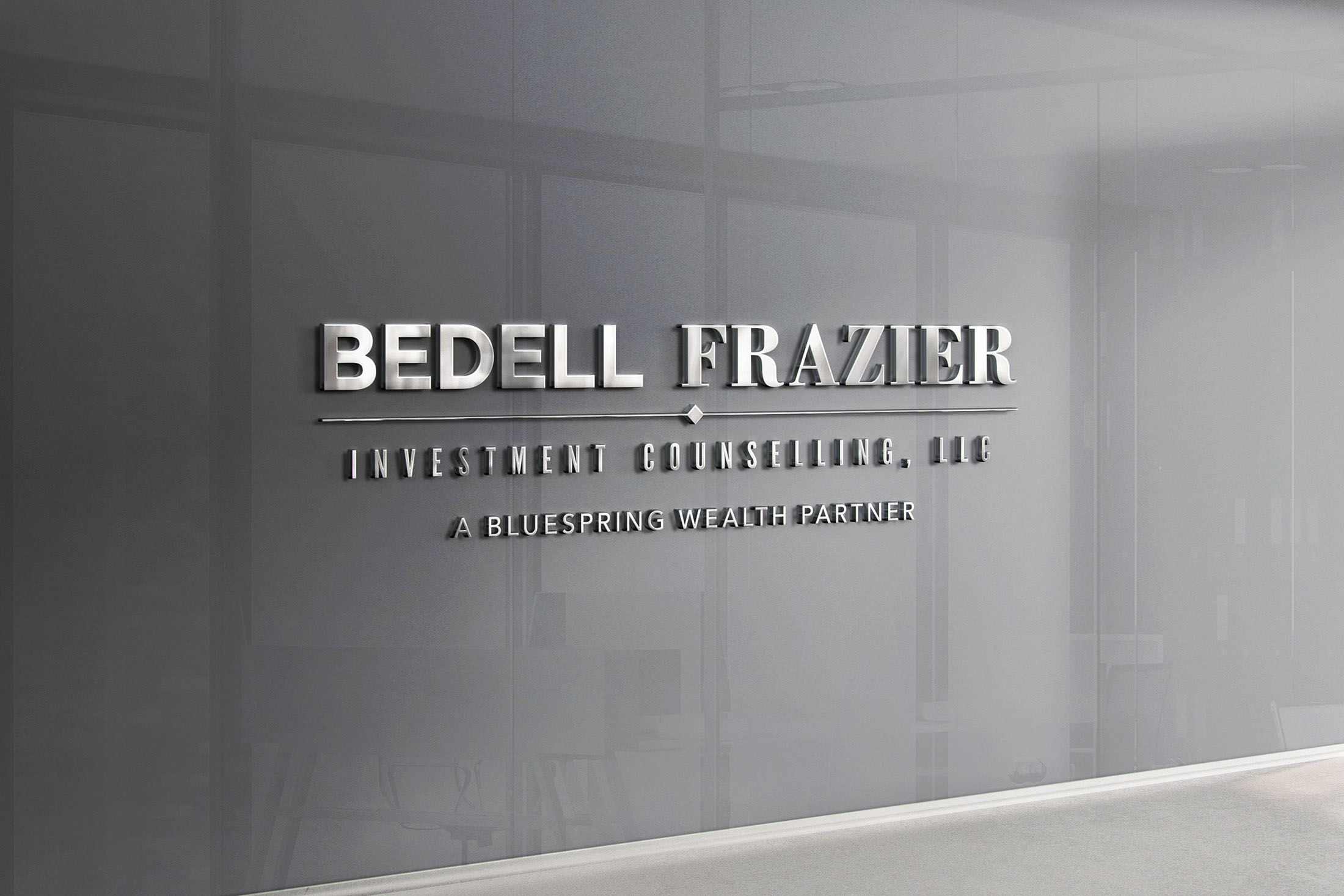 Bedell Frazier Investment Counselling logo as a sleek silver signage mounted on a modern office wall.