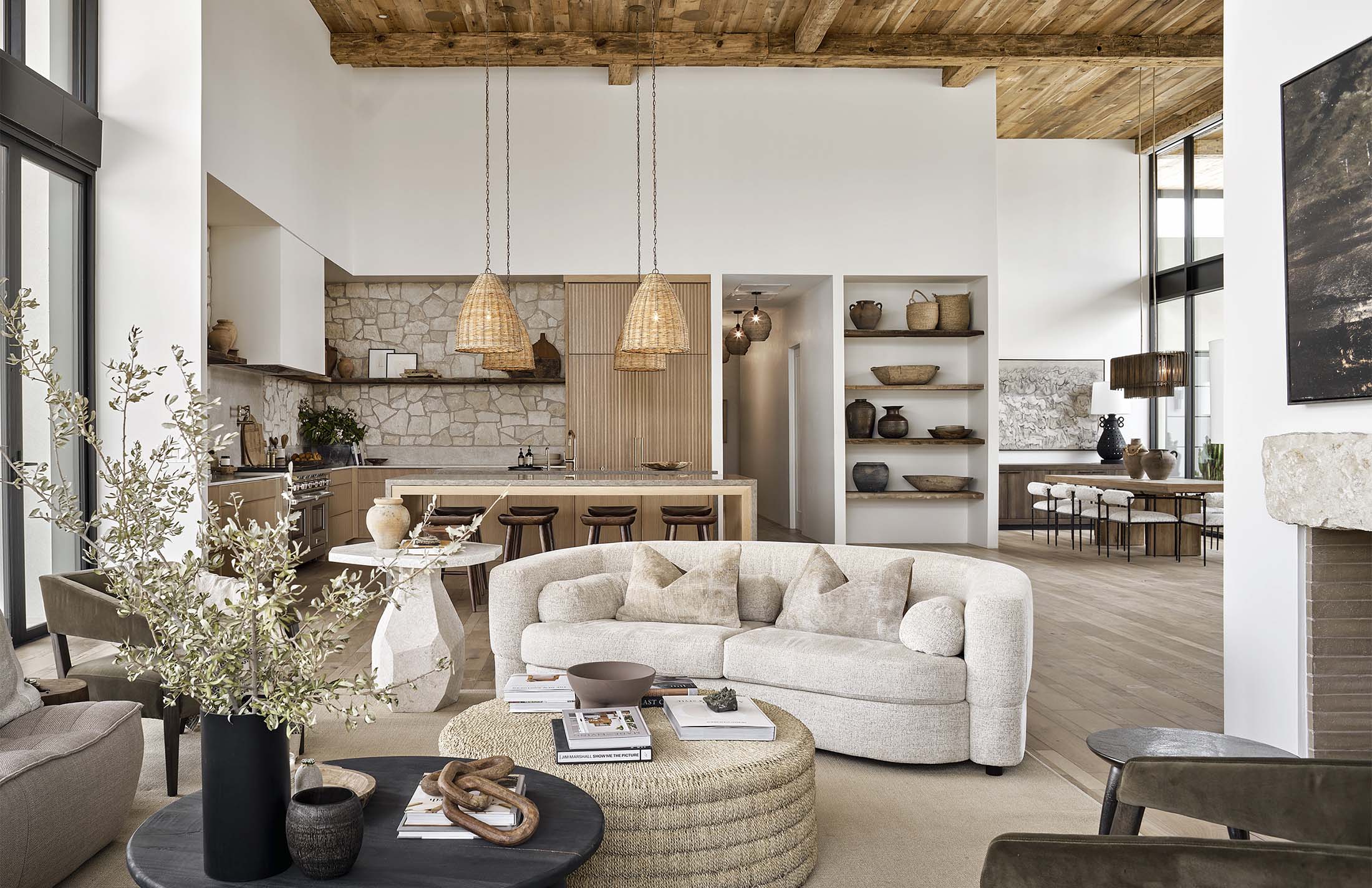 Elegant living room design with natural textures, wooden elements, and open shelving from Modern Nest’s custom home projects.