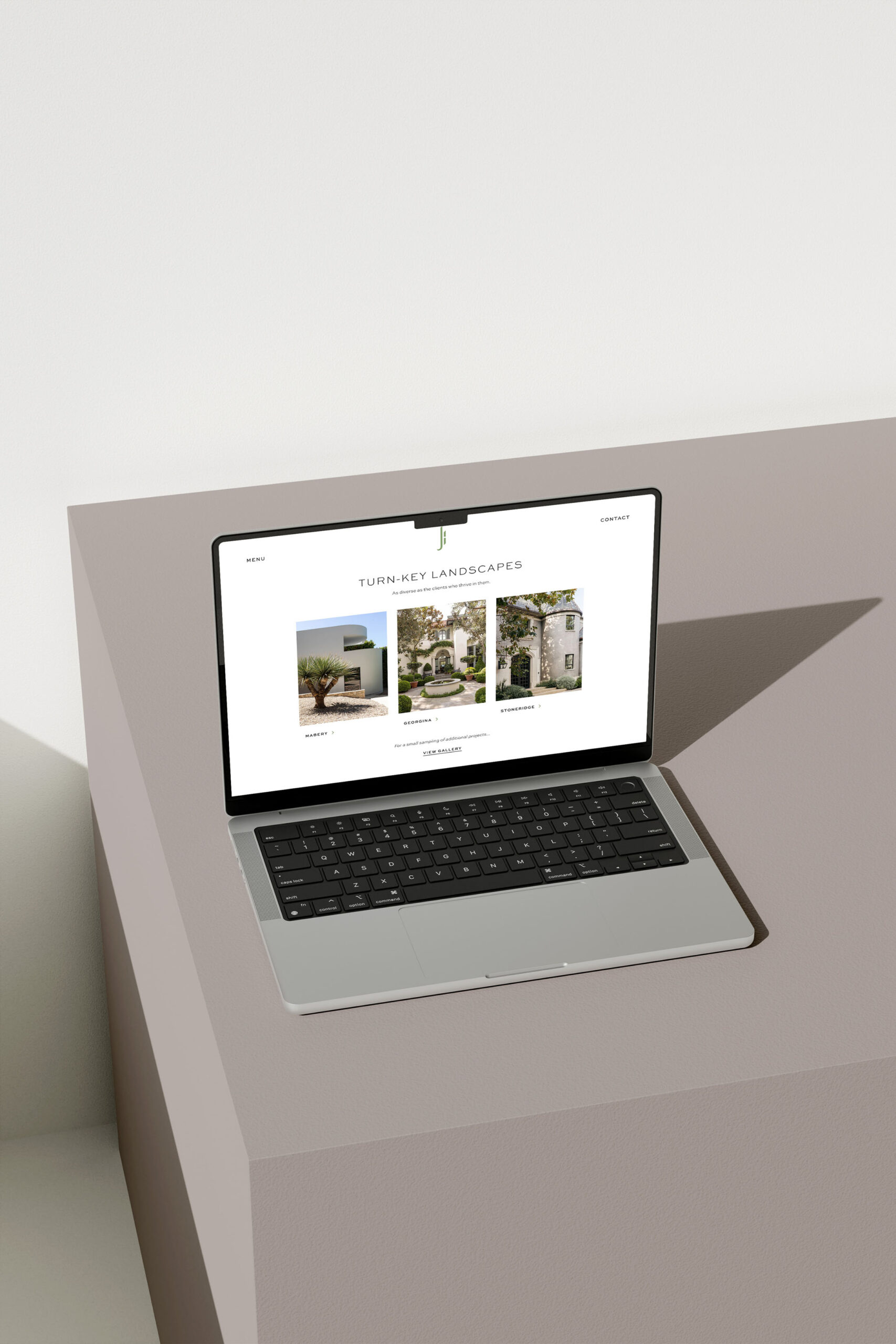 A laptop displaying the ‘Turn-Key Landscapes’ portfolio page, featuring project thumbnails and descriptions in a clean, modern design.