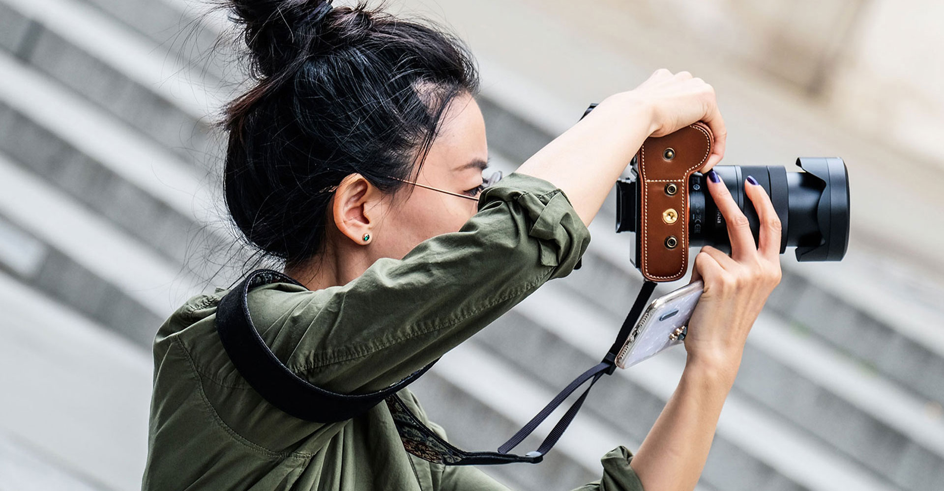 Professional photographer capturing outdoor images with a DSLR camera, showcasing tips for using stock photography to enhance branding and website visuals.