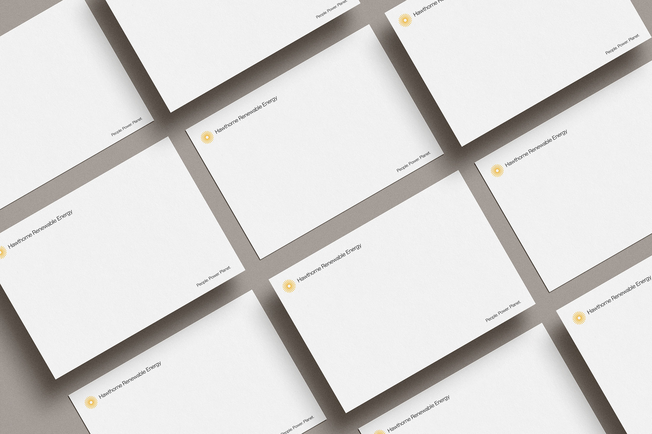 Grid of Hawthorne Renewable Energy envelopes displaying the company name, yellow sunburst logo, and tagline “People. Power. Planet.” on a clean white design.