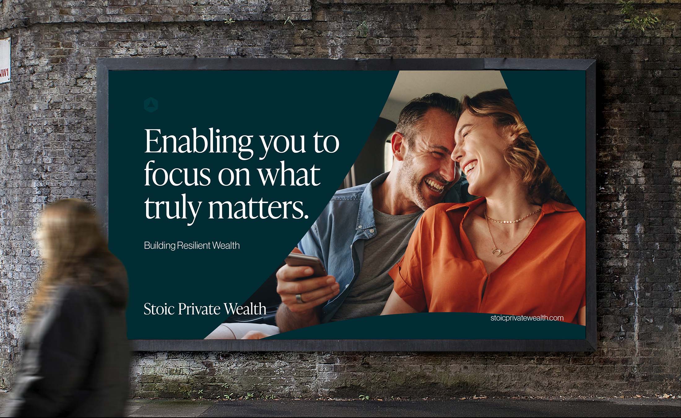 Stoic Private Wealth brand billboard featuring a smiling couple and the message “Enabling you to focus on what truly matters. Building Resilient Wealth.”