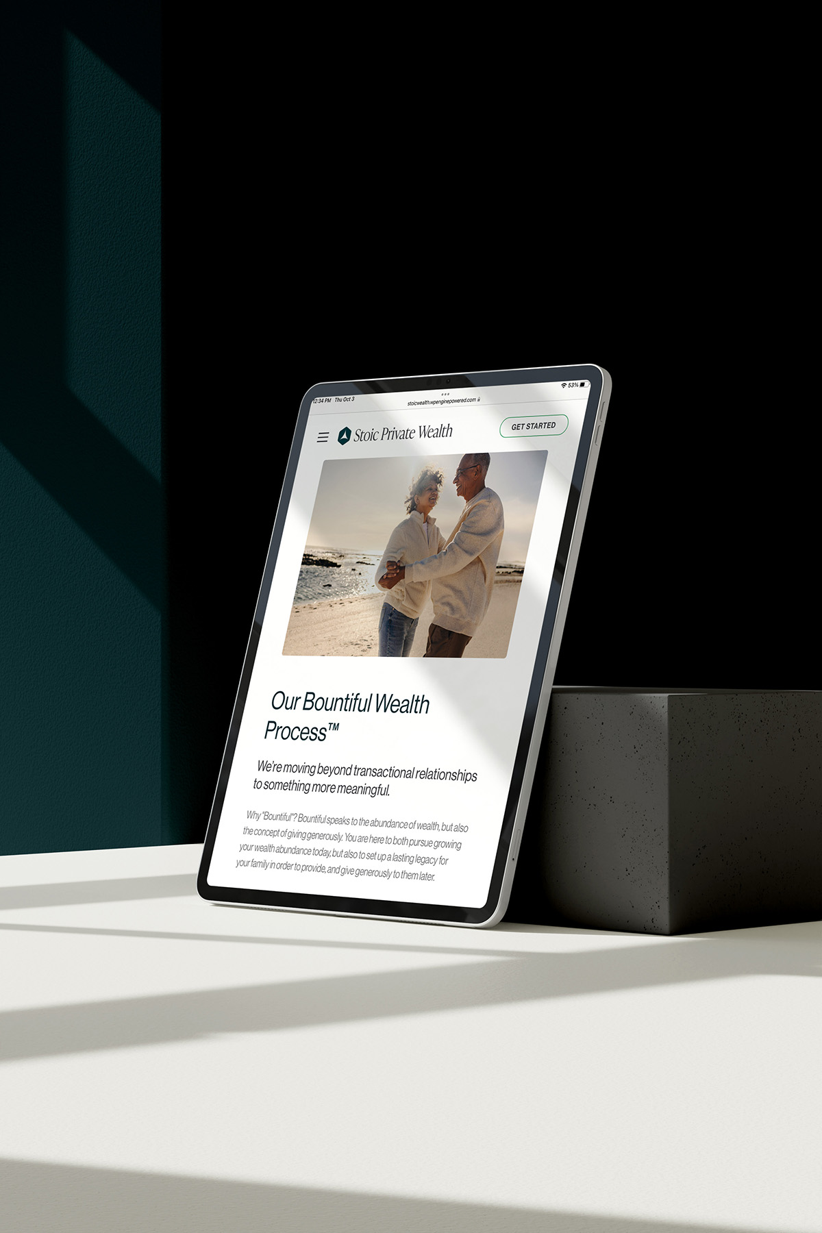 Tablet displaying the Stoic Private Wealth website, featuring the “Our Bountiful Wealth Process” section with an image of a couple embracing on a beach.