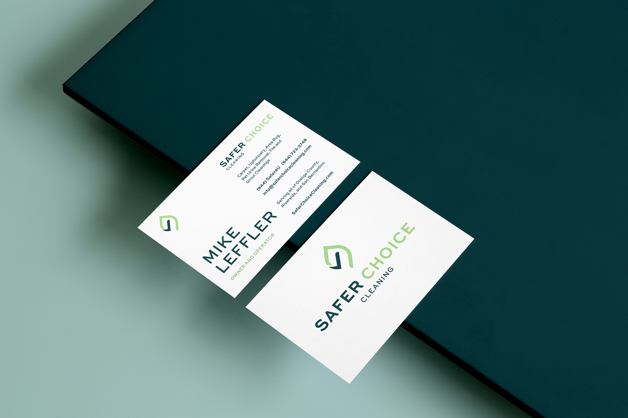 Safer Choice Cleaning branded business cards featuring a clean, modern design with the green and navy logo, bold typography, and contact details for owner Mike Leffler.