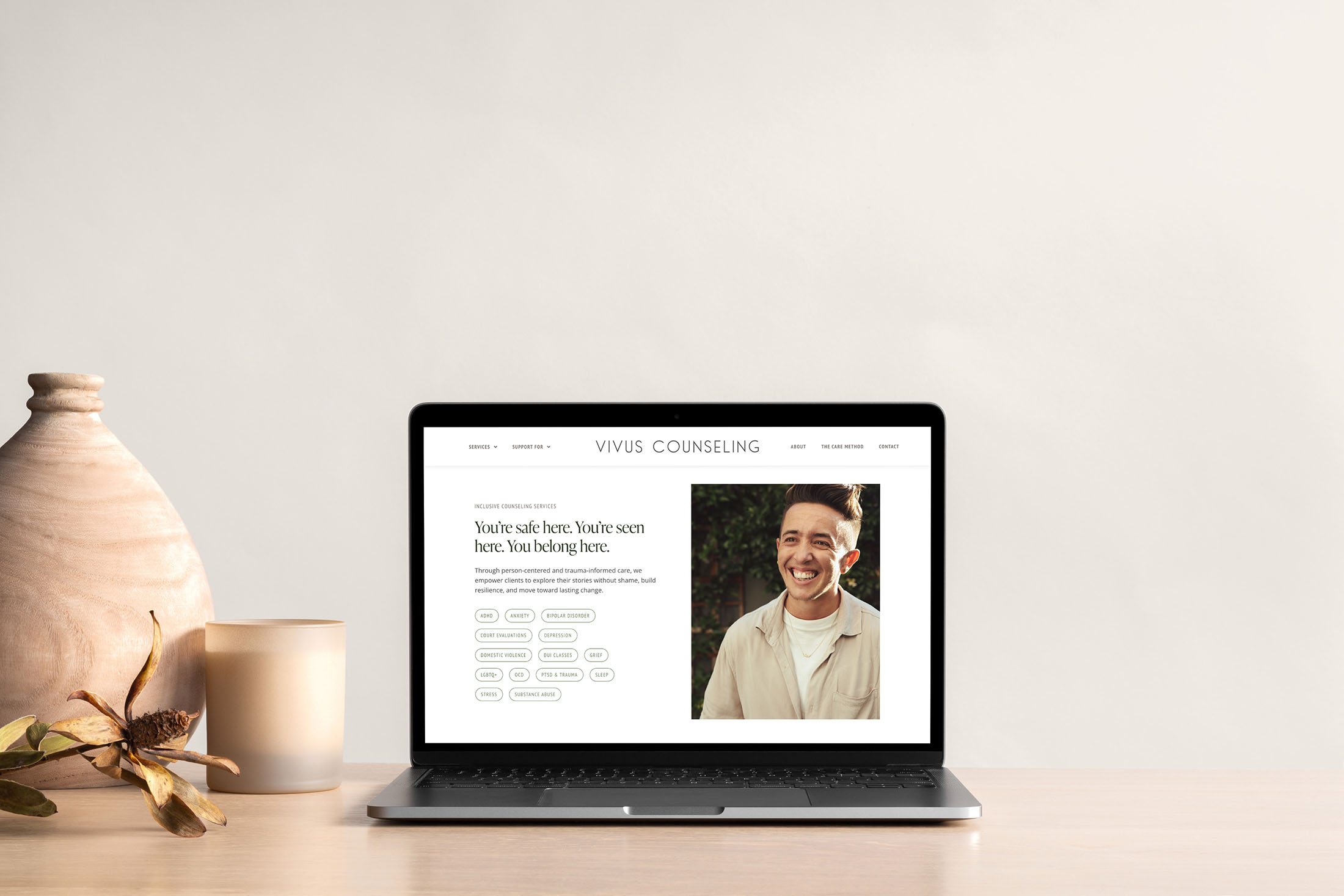 Vivus Counseling website on laptop highlighting “You’re safe here, you belong here” inclusive counseling message with smiling client portrait.
