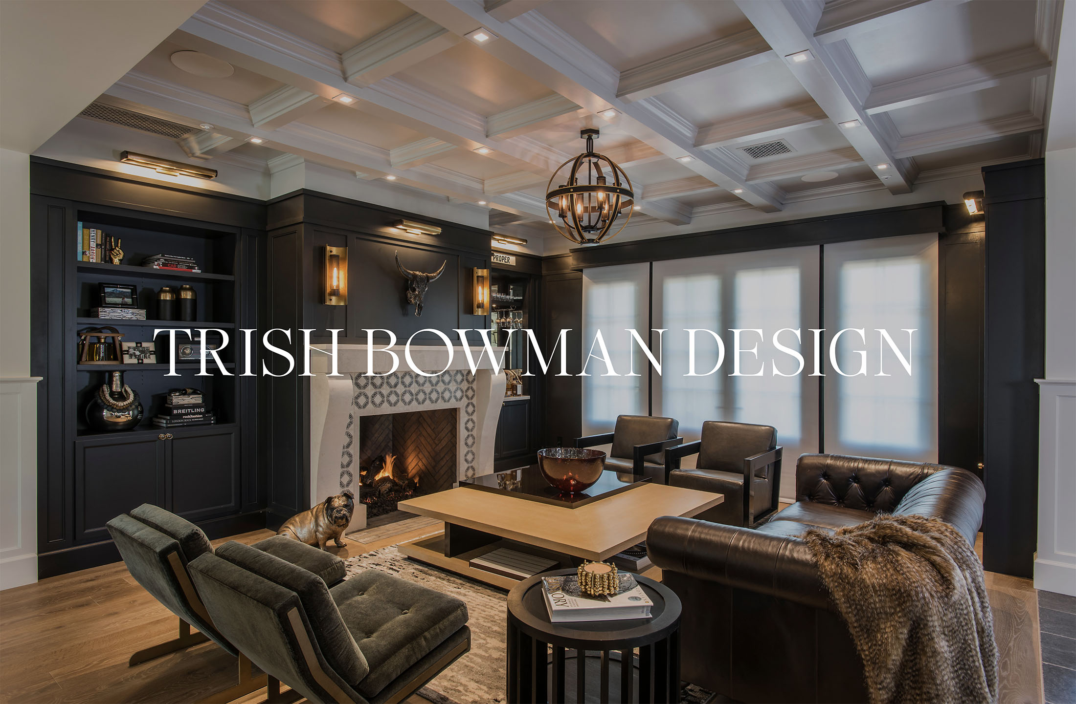 Logo design for Trish Bowman Design featuring a moody, sophisticated living room with black walls, a coffered ceiling, and a cozy fireplace.