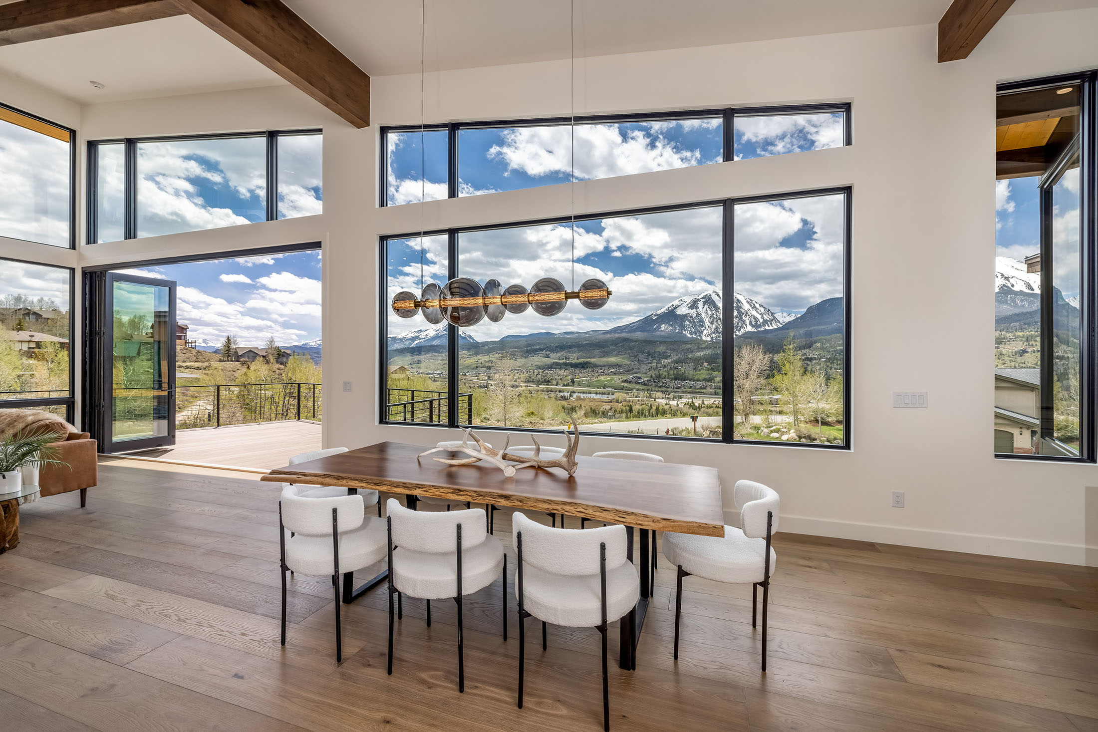 Custom dining area with panoramic mountain views inside a Sweet Homes of Colorado residence