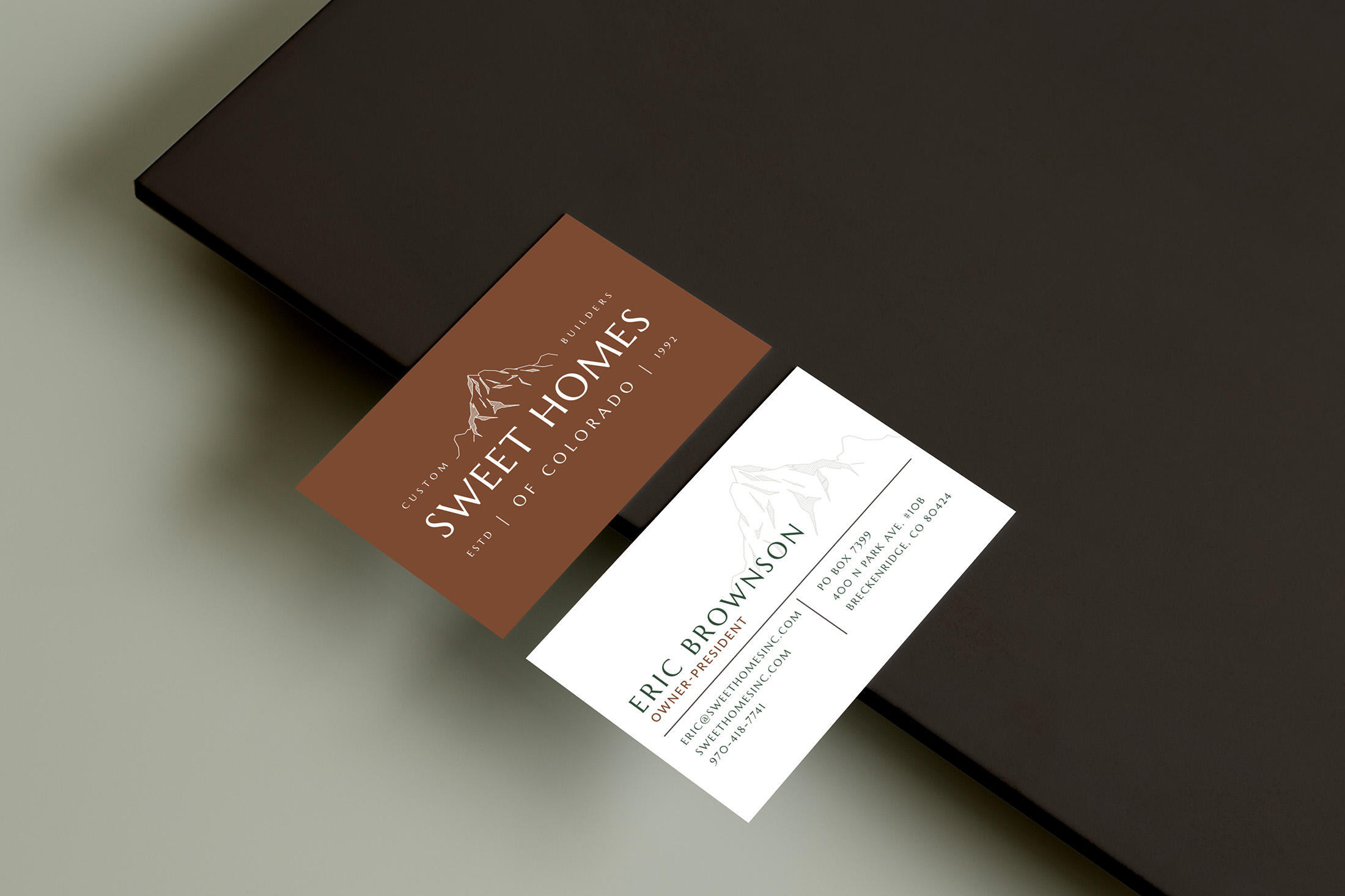 Sweet Homes of Colorado branded business cards featuring mountain iconography and warm, natural color tones.